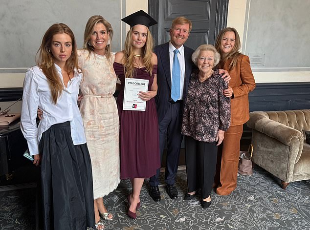 Princess Alexia shows off a sticker on her phone that says 'Matcha Princess' while attending Amsterdam University's ceremony for her sister Princess Amalia's graduation on Monday (pictured L-R: Princess Alexia; Queen Maxima; Princess Amalia; King Willem Alexander; Princess Beatrix; Princess Ariane)