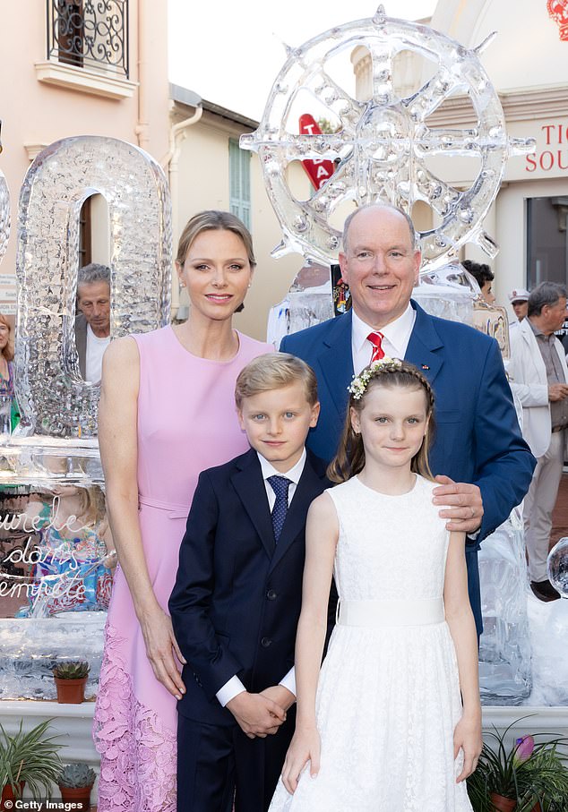 The Prince and Princess of Monaco were spotted beaming alongside their two children during a glorious ceremony to mark the monarch's 20-year reign