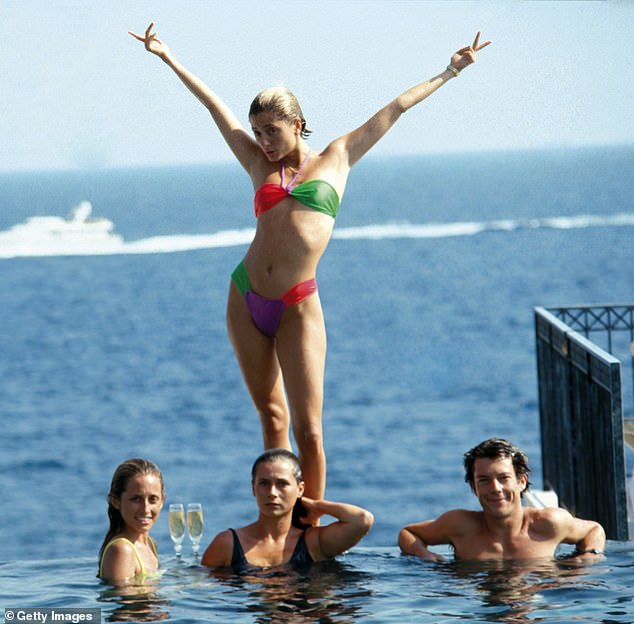 Marie Chantal Miller strikes an extravagant pose above her sister Pia (in yellow) at a pool in the Hotel Belair, Cap Ferrat, July 1991