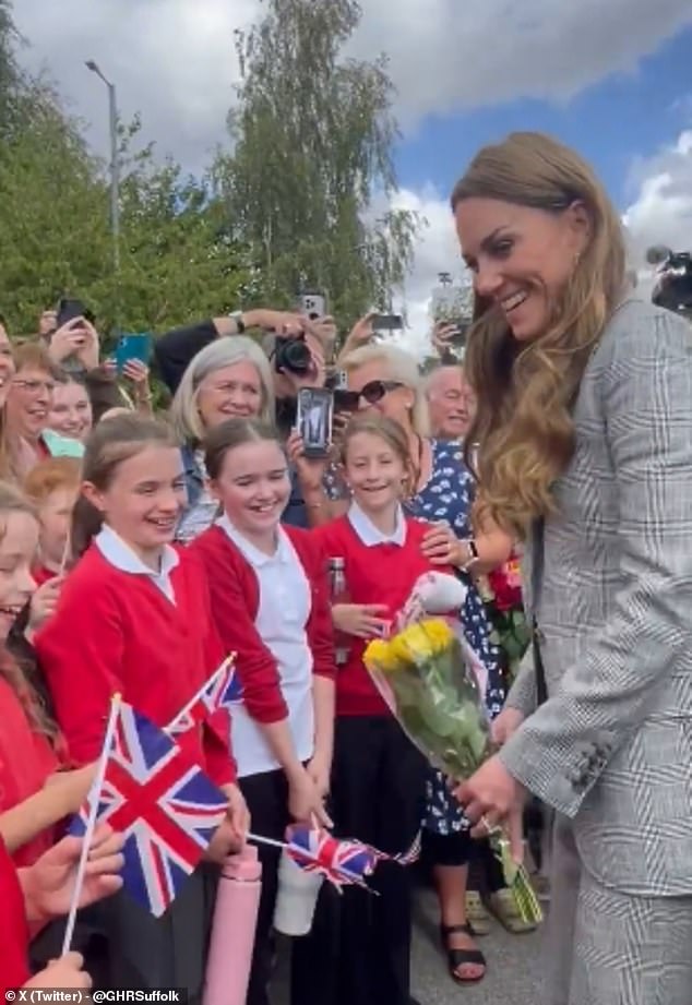 The Princess of Wales left a group of schoolgirls giggling yesterday as she stopped to chat with them about their school holidays (pictured)