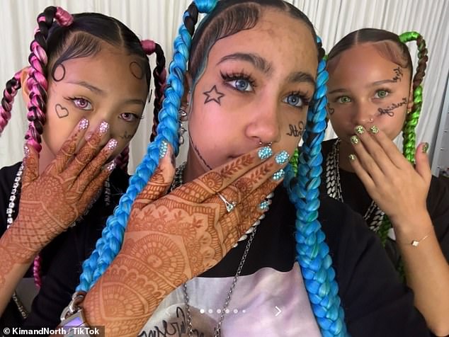Kim Kardashian's daughter North West has debuted a shocking new look that included fake face tattoos, piercings and grillz